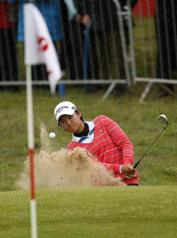 Taiwan’s Yani Tseng hits out of a bunker on the 18th hole Friday during the second round of the Women’s British Open at Royal Birkdale Golf Club in Southport, England. Tseng finished with a 68 for an 8-under-par 136 and the 36-hole lead.