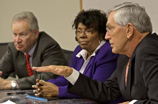 Arkansas State University System interim President Robert Potts (from left), board of trustees Chairman Florine Milligan and Tom Meredith of Effective Leadership talk Friday about the search for a new system president.