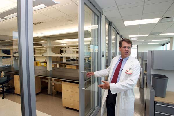 FILE PHOTO: Dr. Peter Emanuel, director of the Winthrop P. Rockefeller Cancer Institute, shows off laboratory space in 2010.