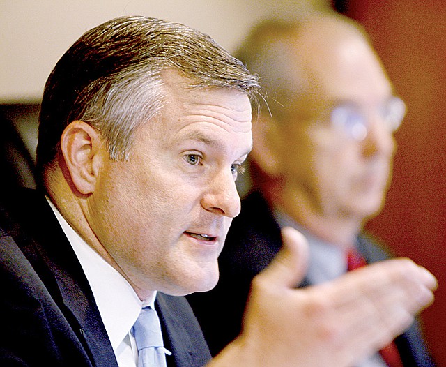 Paul Suskie (left), chairman of the Public Service Commission, speaks during a hearing Monday about Entergy Arkansas’ system agreement, with Commissioner Olan Reeves alongside.
