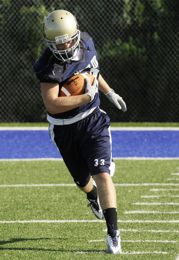 Shiloh Christian’s Colt Thomas completes an offensive drill Monday drill in Champions Stadium in Springdale.
