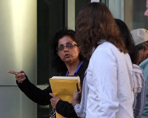 Sangeeta Mann, who faces charges along with her husband, Randeep Mann, in a federal bombing case, leaves court in Little Rock on Wednesday with family members. 
