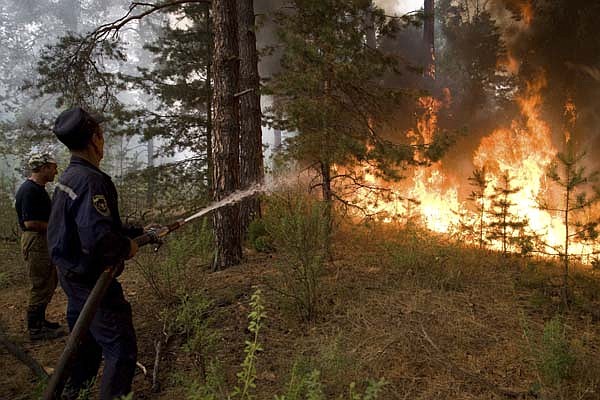Firefighters tackle a wildfire Friday near the village of Murmino in the Ryazan region, southeast of Moscow.