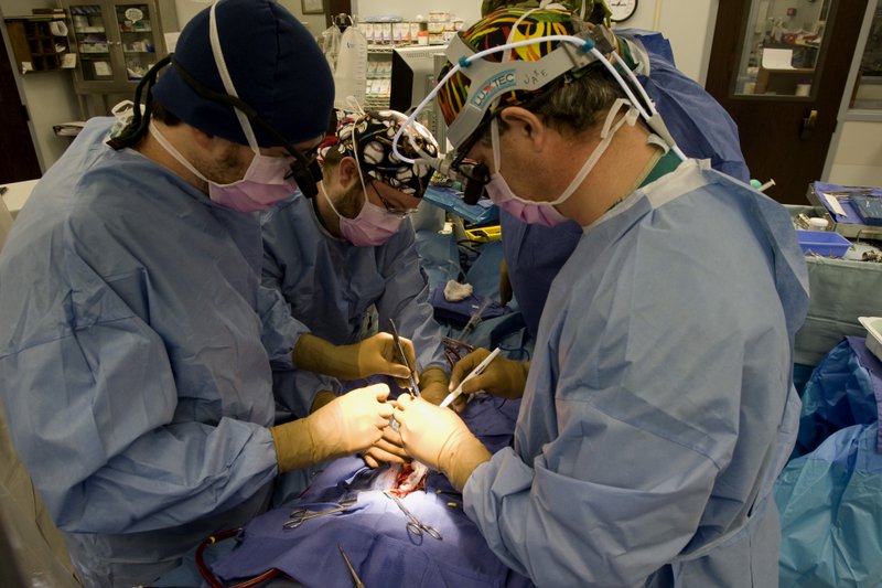 Dr. Robert Jaquiss (right) performs heart-transplant surgery on Christopher Schroeder at Arkansas Children’s Hospital with registered nurse Richard Frizzell (center) and physician assistant Ed Horgan.
