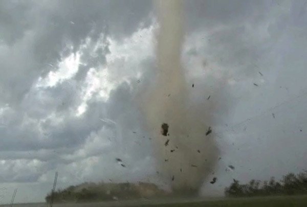 In this Aug. 7, 2010 image made from APTN video, debris flies through the air as a tornado moves through rural Wilkin County, Minn.