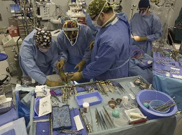 Nurses Richard Frizzell and Michael Tucker assist Dr. Robert Jaquiss as they prepare a donor heart for transplant into infant Christopher Schroeder. Most of the time when an organ transplant saves a life, it means another person has died.