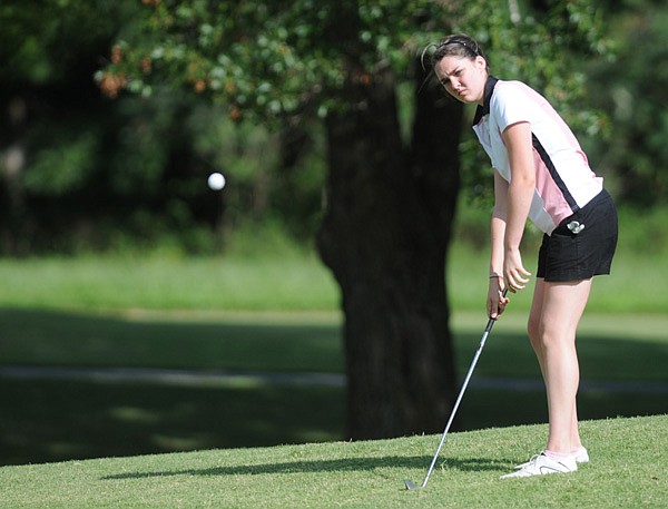 Bentonville’s Christina Johnson chips onto the green July 29 during tryouts for the Lady Tigers’ golf team at Scotsdale Golf Course in Bella Vista.
