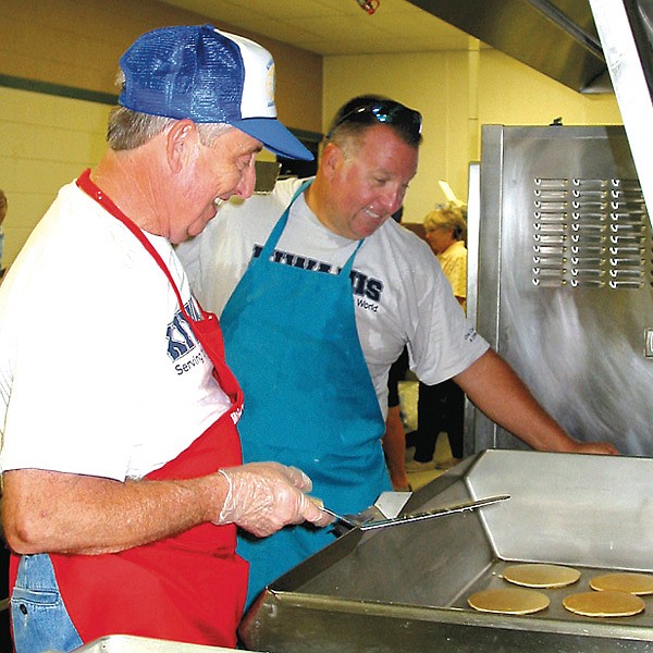 Pancake flippers Bob Kelley and Ken Foxx prepare for the Kiwanis breakfast on Saturday.