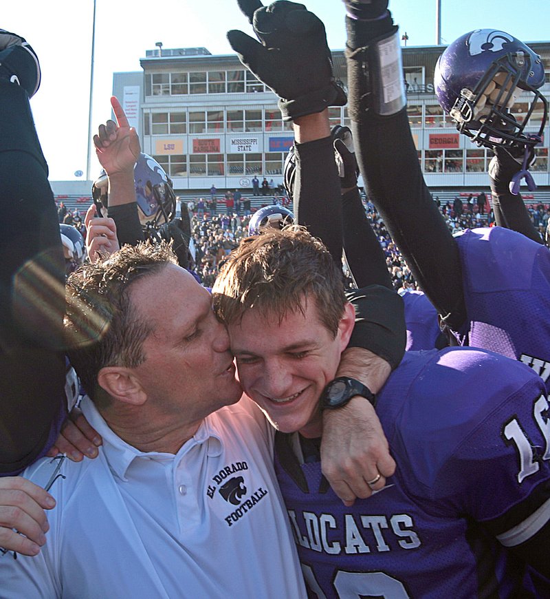 El Dorado Coach Scott Reed celebrates with his son, Wildcats quarterback Taylor Reed, after winning the Class 6A state title last season with a 27-20 victory over Pine Bluff. The Reeds may have a good shot at repeating their celebration this year, as 12 starters return to the team.