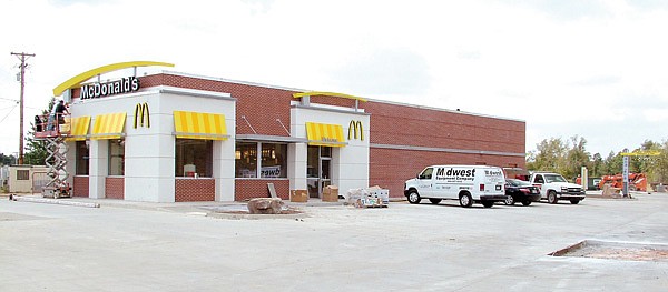 Workers finish up trim work on the exterior of the new McDonald's Restaurant set to open in Gentry next week.