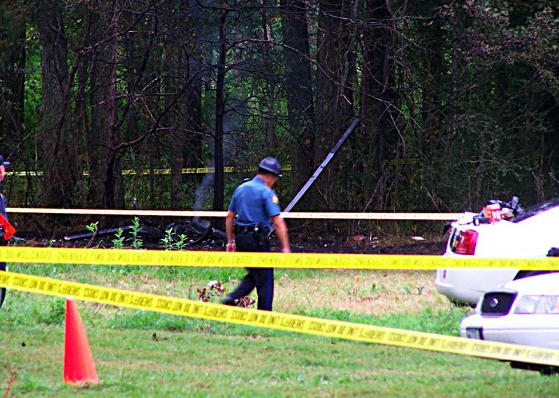 An officer walks near the site of a medical helicopter crash Tuesday.