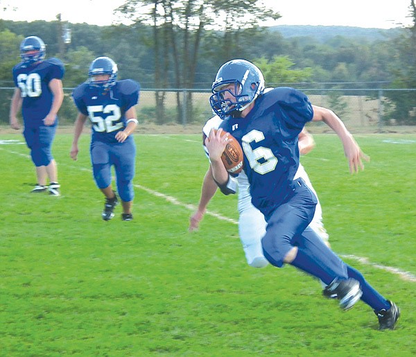 Evan Owens ran the ball during a scrimmage game against Gentry's sophomore team on Monday night. The teams held a close tie of 6 to 6, then 12 to 12 for most of the game until Gentry scored in the fourth quarter for a win of 18 to 12.