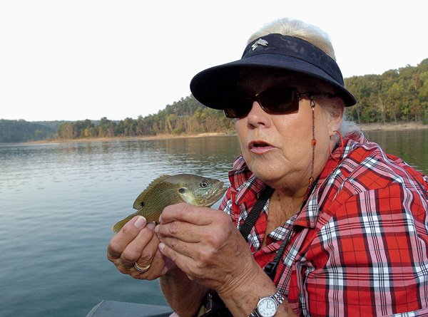 Sallyann Brown says “thanks” to a green sunfish before releasing it. Brown caught the feisty sunfish on a deer-hair popper she made herself.