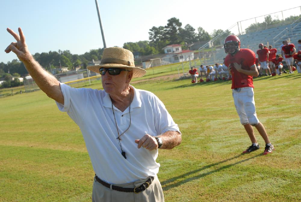 Harmony Grove head football coach Red Parker works with the team on their punt return.