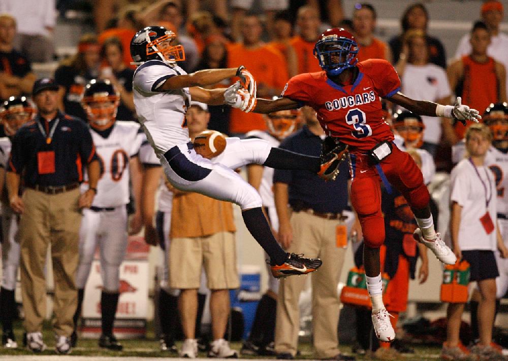 Arkansas Democrat-GazetteRYAN MCGEENEY --09-02-10--Rogers Heritage defensive back Colin Roberts strips a pass intended for Helena wide receiver Scott Henry during Thursday night's game at Razorback Stadium.