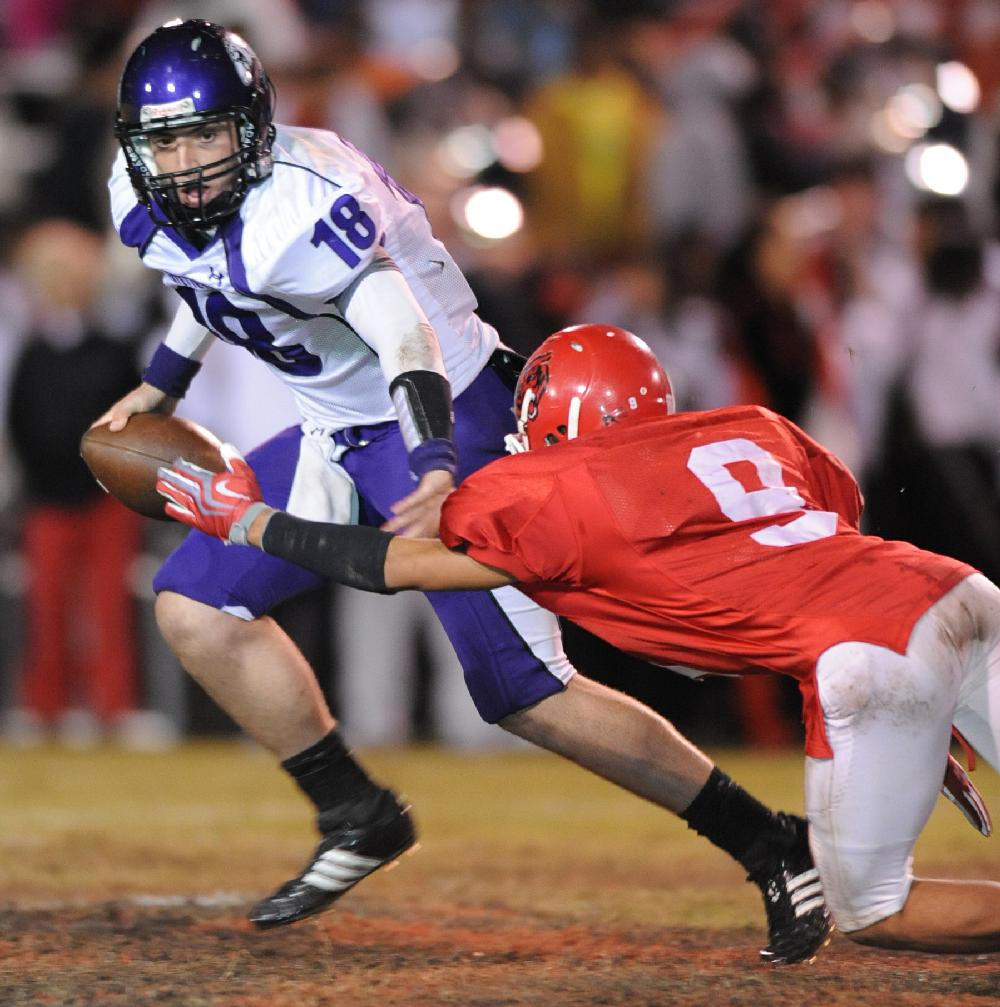 ANDY SHUPE Northwest Arkansas TimesFayetteville junior quarterback Brandon Allen, left, reaches to fend off Fort Smith Northside senior defender Salih Willis during the first second of play Friday at Mayo-Thompson Stadium in Fort Smith.