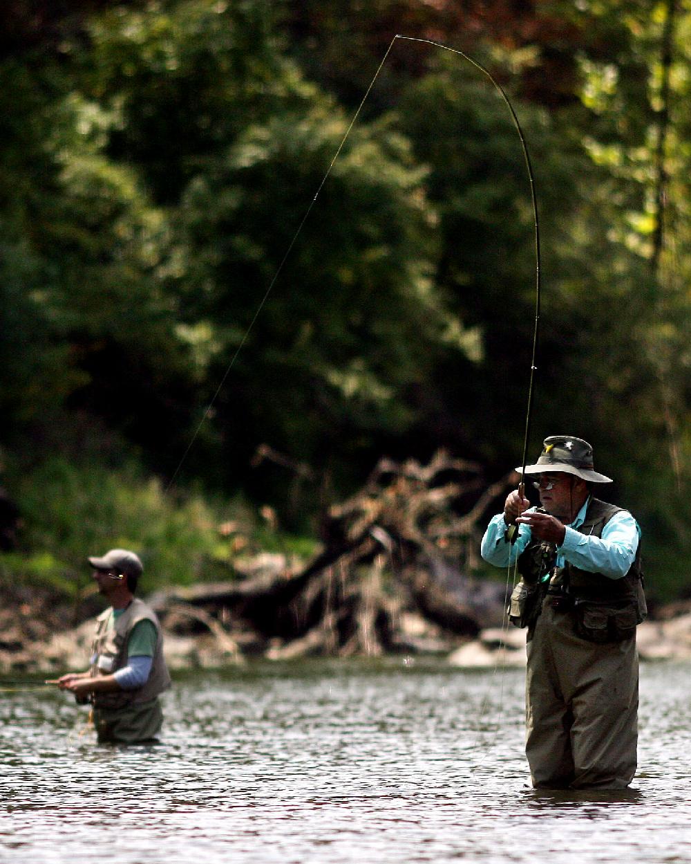 Arkansas Democrat-GazetteWILLIAM MOORERonnie Atnip (cq) of Bonham, TX plays a rainbow while fishing during zero generation on the White River with his son-in-law Brian Gibson (L) of Melissa, TX below Beaver Dam Thursday, September 2, 2010 outside of Rogers. Atnip says he has been coming up to fish the White for 40 years.