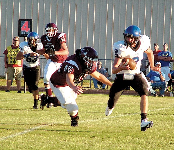 Gentry senior Eathen Ramsey makes Colcord quarterback Canaan Sherrell scramble during the Friday night portion of the game between the Gentry Pioneers and the Colcord (Okla.) Hornets.