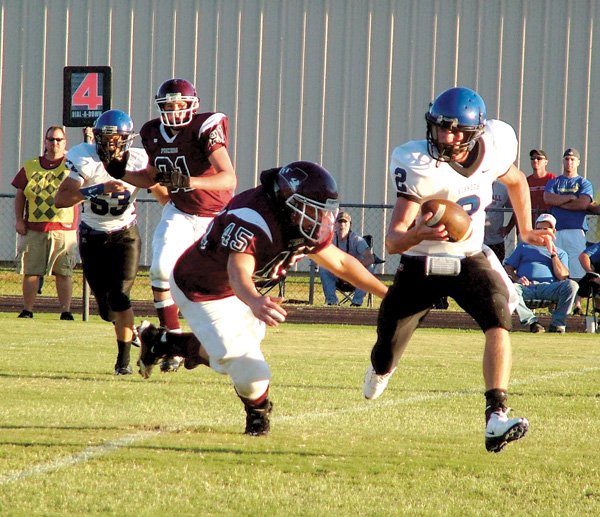 Gentry senior Eathen Ramsey makes Colcord quarterback Canaan Sherrell scramble during the Friday night portion of the game between the Gentry Pioneers and the Colcord (Okla.) Hornets.