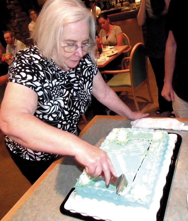 JoAnne Hall cuts her cake at a retirement party held last week in Bella Vista. Hall taught and served as a librarian in the Decatur School District for 33 years.