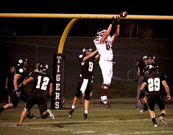 Surrounded by Charleston Tigers, Kevin Sherer jumps to receive a touchdown pass from Austin Millsap in the second quarter — the second TD of the game for Gentry in their Friday night victory over Charleston.
