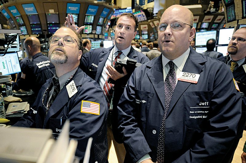 Douglas Johnson, left, and Jeffrey Heyman, right, both of Banc of America Specialist Inc., and Jonathan Corpina, center, of Meridian Equity Partners, work on the floor of the New York Stock Exchange, Tuesday, Sept. 21, 2010, in New York. 