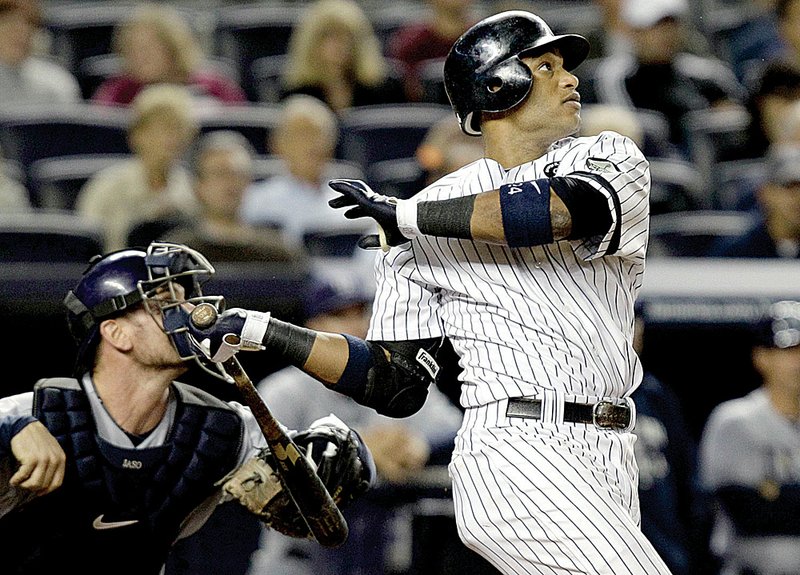 New York’s Robinson Cano watches the flight of his seventh-inning, two-run double in the Yankees’ 8-3 victory over Tampa Bay on Tuesday night. 