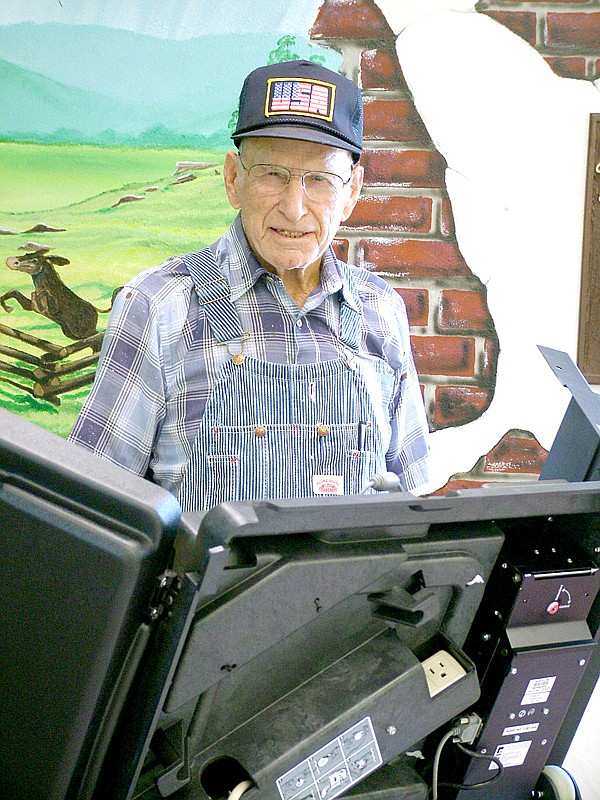 School elections were Tuesday. At left, Russell Walker, 93, a 1937 graduate of Pea Ridge High School, cast his vote.