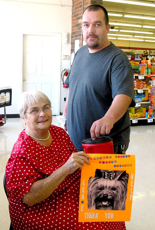 Eda Montag is pictured collecting donations to benefit the Gravette animal shelter. Making a contribution is Chris McGarrah.
