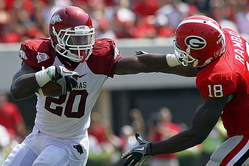 Arkansas running back Ronnie Wingo tries to fend off a tackle by Georgia’s Bacarri Rambo in the Razorbacks’ 31-24 victory over the Bulldogs in Athens, Ga., on Saturday. 