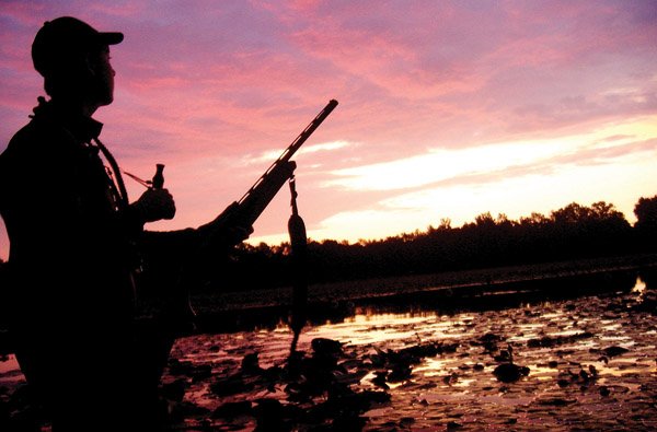 John Keith of Conway watches the sunrise and waits for teal during opening day on Sept. 11.