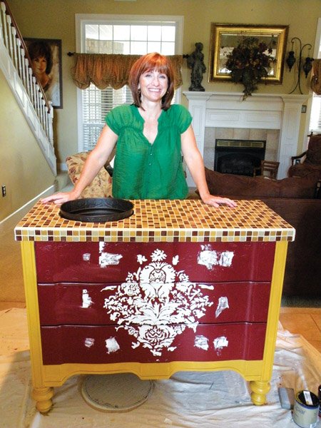 Maret Moore of Conway is creating this wet bar or potting bench to donate to the ninth annual Festival of Chairs. Moore took an old dresser, covered the top with glass tiles and added feet to the dresser for a unique look. She and her husband, Jim, are longtime supporters of Friends of CASA and are this year’s honorary chairmen of the event, which raises funds for the Children’s Advocacy Alliance of North Central Arkansas, the umbrella organization of Court Appointed Special Advocates of the 20th Judicial District and the Central Arkansas Children’s Advocacy Center. 