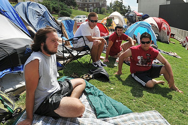 University of Arkansas students (from left) J.P. Turchi, Jacob Parker, Chris Wendel and Juan Oseguera hang out in front of their tents Friday as they talk about Saturday’s game between the Razorbacks and No. 1-ranked Alabama. 