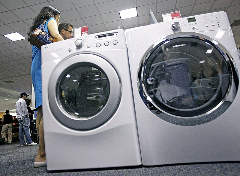 Shoppers look at a washer and dryer Friday during a promotion sale of Energy Star appliances at a store in Glenview, Ill.