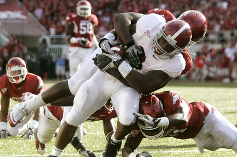 Alabama running back Trent Richardson drags Arkansas defensive lineman D.D. Jones into the end zone for a third-quarter touchdown Saturday at Reynolds Razorback Stadium in Fayetteville. The 20-yard touchdown, coming after a pass from Greg McElroy, narrowed Arkansas’ lead to 20-14 in a 24-20 Alabama victory. 