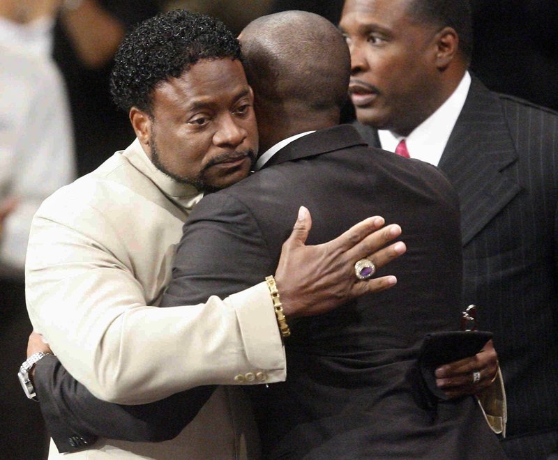 Bishop Eddie Long, left, embraces a friend, Sunday, Sept. 26, 2010, at New Birth Missionary Baptist Church in Atlanta. Long, the pastor of a Georgia megachurch  accused of luring young men into sexual relationships, has told his congregation of thousands that all people must face painful and distasteful situations. 