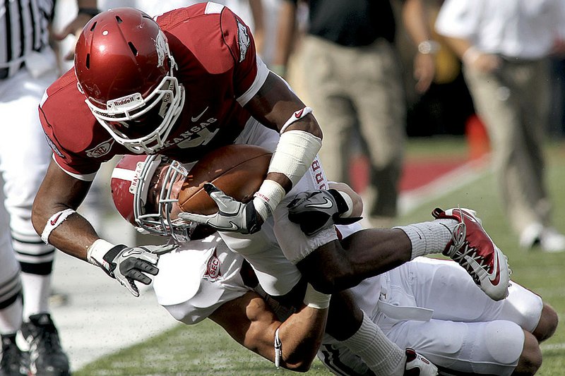 Arkansas wide receiver Jarius Wright is tackled by Alabama defensive back Robert Lester during the first quarter of the Razorbacks’ 24-20 loss to top-ranked Alabama on Saturday in Fayetteville.