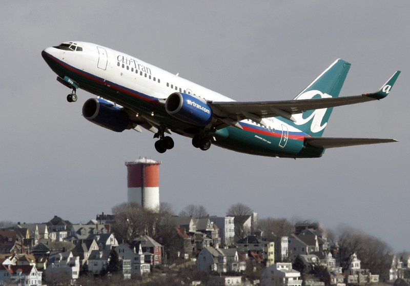 An AirTran plane leaves Logan International Airport in Boston in this 2007 file photo. Southwest Airlines is buying AirTran for about $1.4 billion. 
