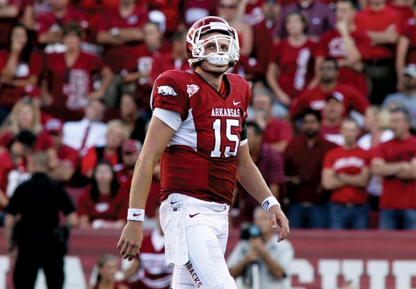 A dejected Ryan Mallett walks off the field following Arkansas' heartbreaking 24-20 loss to Alabama.