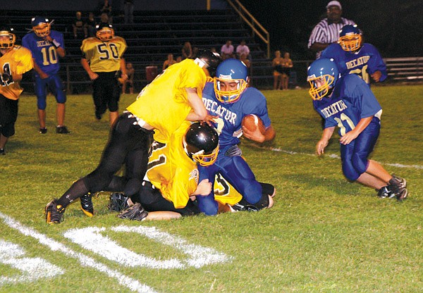 Decatur's junior high player Alan Casteneda is stopped on a run against Hackett on Thursday.
