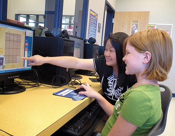School counselor Maolina Yang helped sixth grade student Hailey Busby use the new Kuder Galaxy program on Monday morning.
