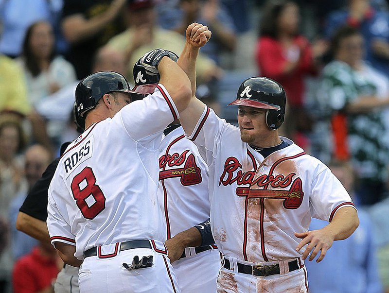  Atlanta third baseman Brooks Conrad celebrates with David Ross after hitting a three-run home run in the third inning Wednesday, helping the Braves to a 5-1 victory over Florida.