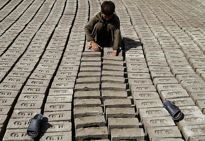 An Afghan boy works at a brickyard Wednesday on the outskirts of Jalalabad in eastern Afghanistan.