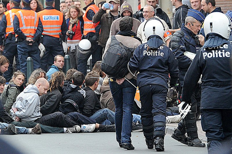 Riot police detain protesters in Brussels on Wednesday during demonstrations against government budget cuts. 
