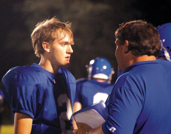  Blake Wilkins receives instructions from coach Stan Ellis during Friday's game.
