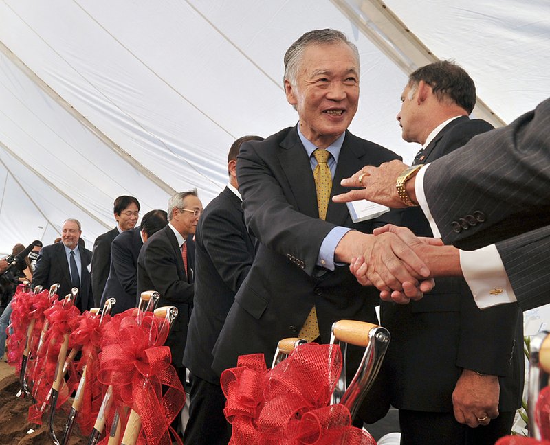 Ichiro Fukue, Vice President of Mitsubishi Heavy Industries, Ltd., shakes hands with Arkansas officials after the groundbreaking for the Arkansas Wind Turbine Assembly Plant in fort Smith Thursday afternoon.