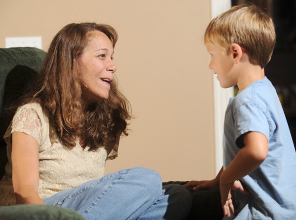 Julie Petty of Fayetteville speaks with her 5-year-old son, Warren, on Wednesday while discussing her plans to travel to Washington to take part in the signing of Rosa’s Law by President Obama.
