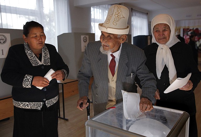 Kyrgyz people cast their ballots at a polling station in the village of Arashan, 20 km. (12 miles) south of the capital Bishkek, Kyrgyzstan, Sunday, Oct. 10, 2010. Voters turned out in force Sunday in Kyrgyzstan for parliamentary elections to choose a new parliament in the hope that it will usher in a new era of democracy, in sharp contrast to the strongman model exercised under President Kurmanbek Bakiyev, who was ousted from power in April 2010 amid violent public demonstrations. A U.S. air base is hosted in Kyrgyzstan which is seen as strategically vital to the conflict in Afghanistan. 
