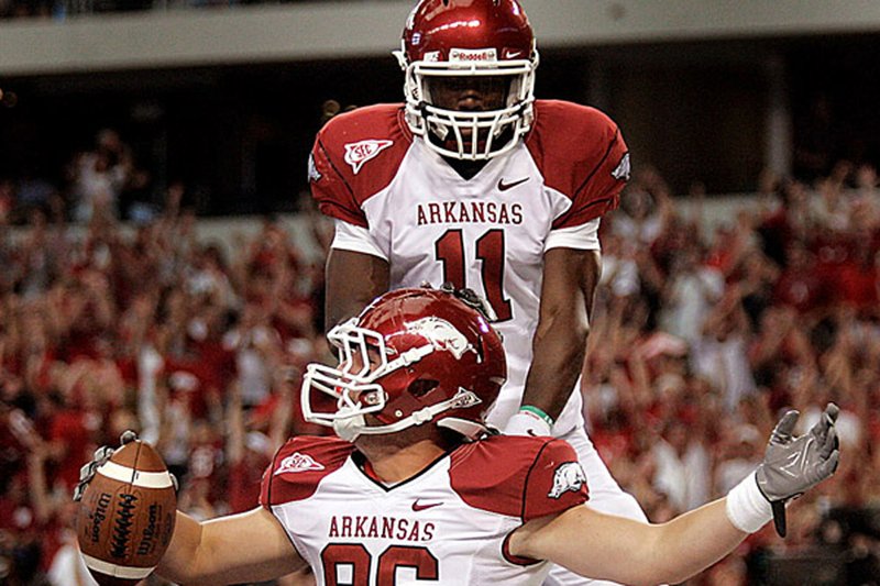 Arkansas wide receiver Cobi Hamilton (top) celebrates with tight end Ben Cleveland following Cleveland’s touchdown reception against Texas A&M during the second quarter of Saturday’s 24-17 Razorbacks victory at Cowboys Stadium in Arlington, Texas.