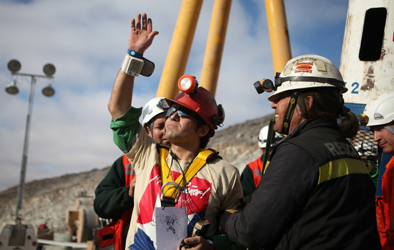 In this photo released by the Chilean government, miner Alex Vega waves after being rescued Wednesday Oct. 13, 2010, from the collapsed San Jose mine, where he had been trapped with 32 other miners for more than two months near Copiapo, Chile.